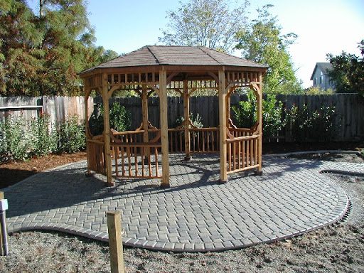 Wood gazebo on a paver patio.