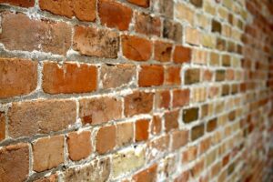 Wall with bricks in different tonesand covered white haze