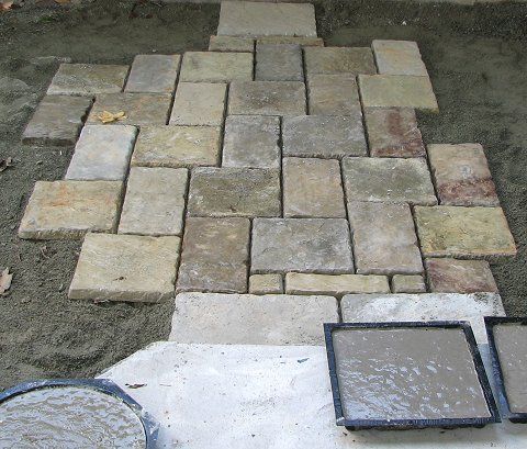 Concrete pavers with an example of mold with wet concrete.
