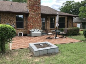 Backyard of a house with paver brick patio.