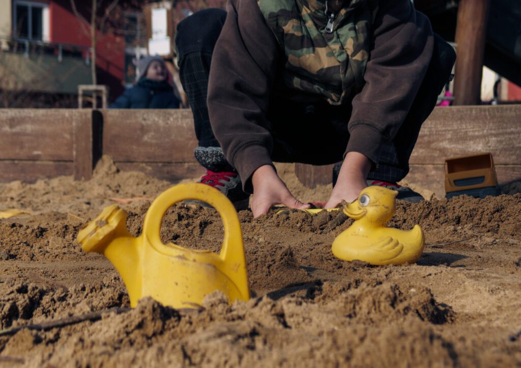 Kid playing on sandbox