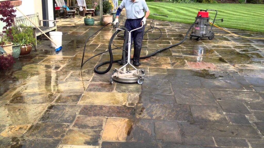 person cleaning pavers