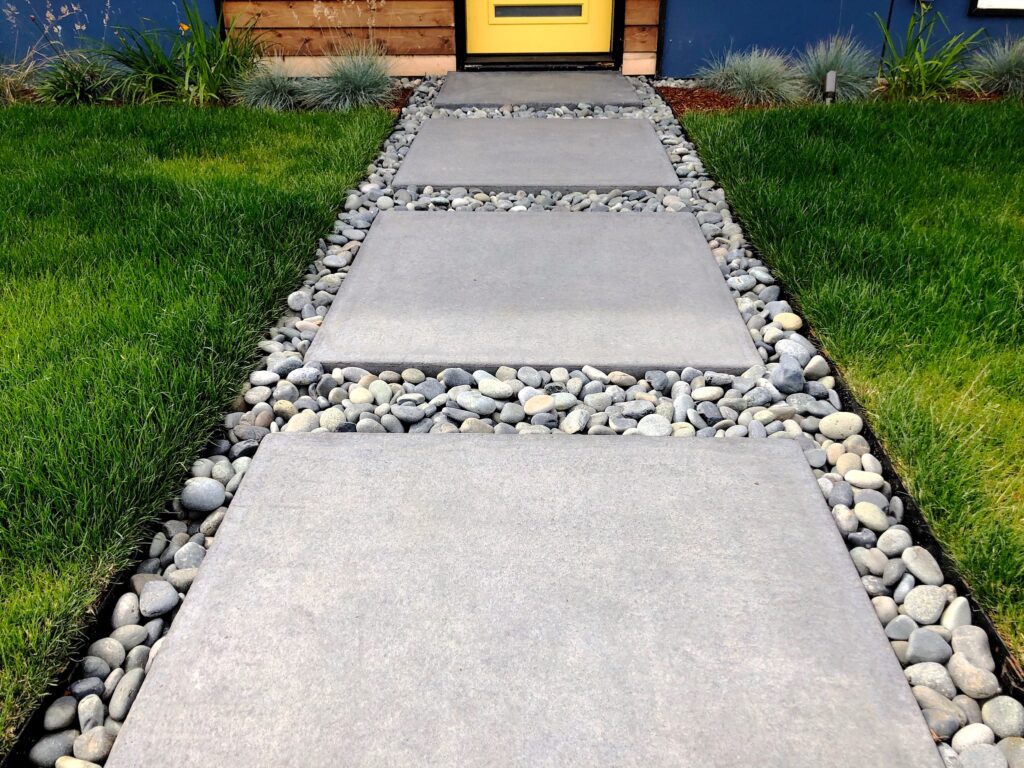 square pavers on pebbles and grass