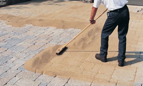 joint sand being spread on pavers